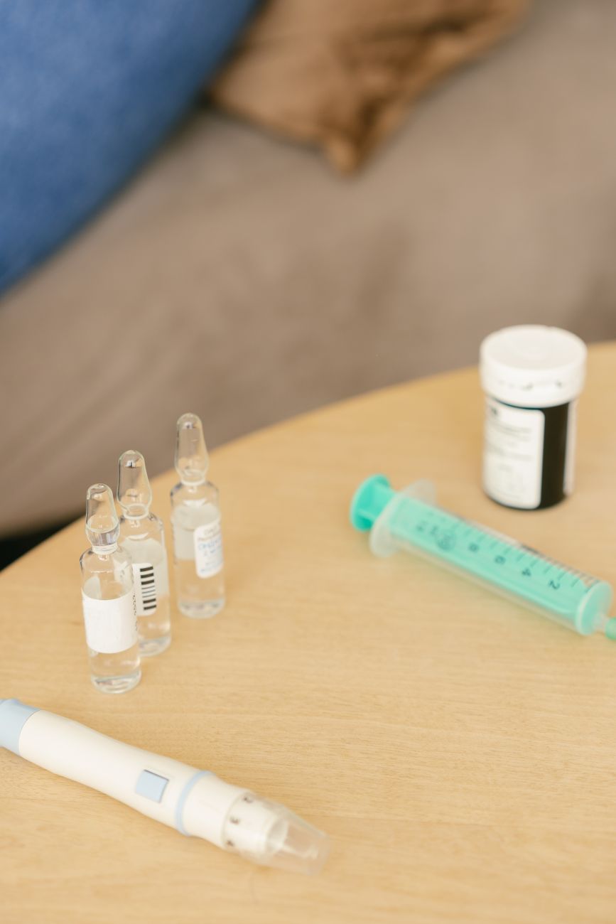 Peptide vials and injection supplies arranged for a CJC-1295, ipamorelin, or tesamorelin dosing routine