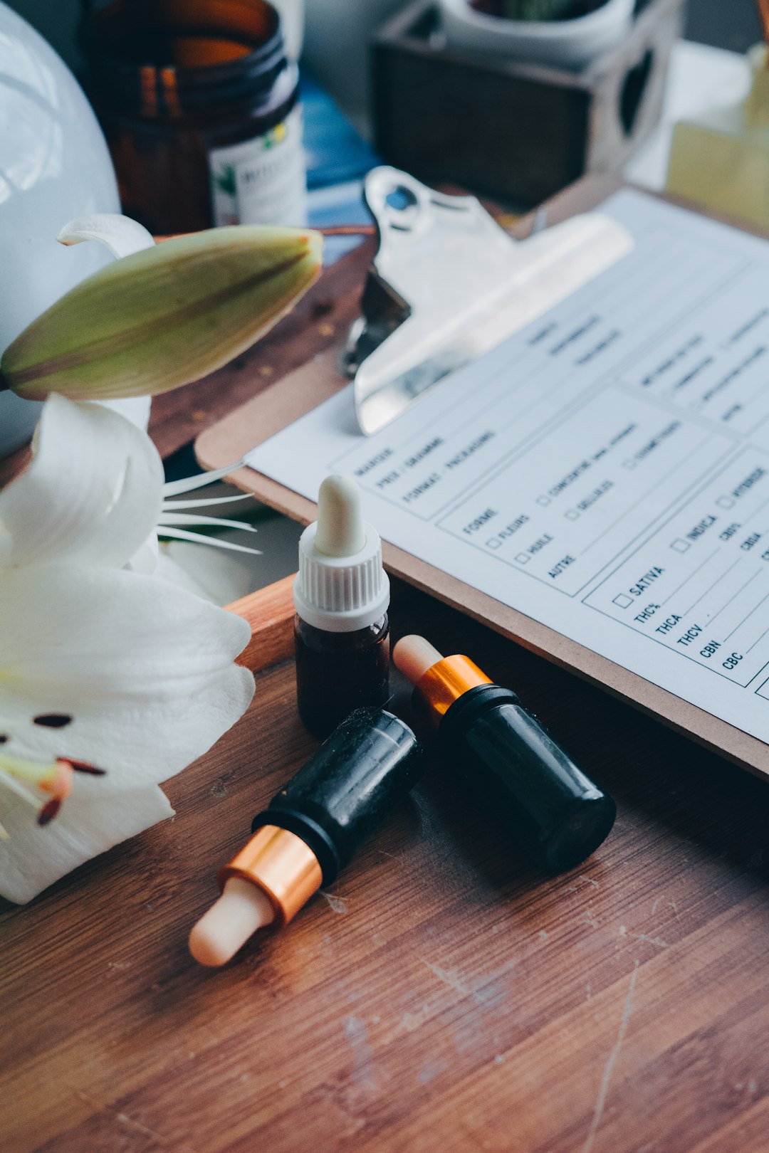 Nasal spray and dropper bottle used for Semax peptide dosing next to a tracking notebook